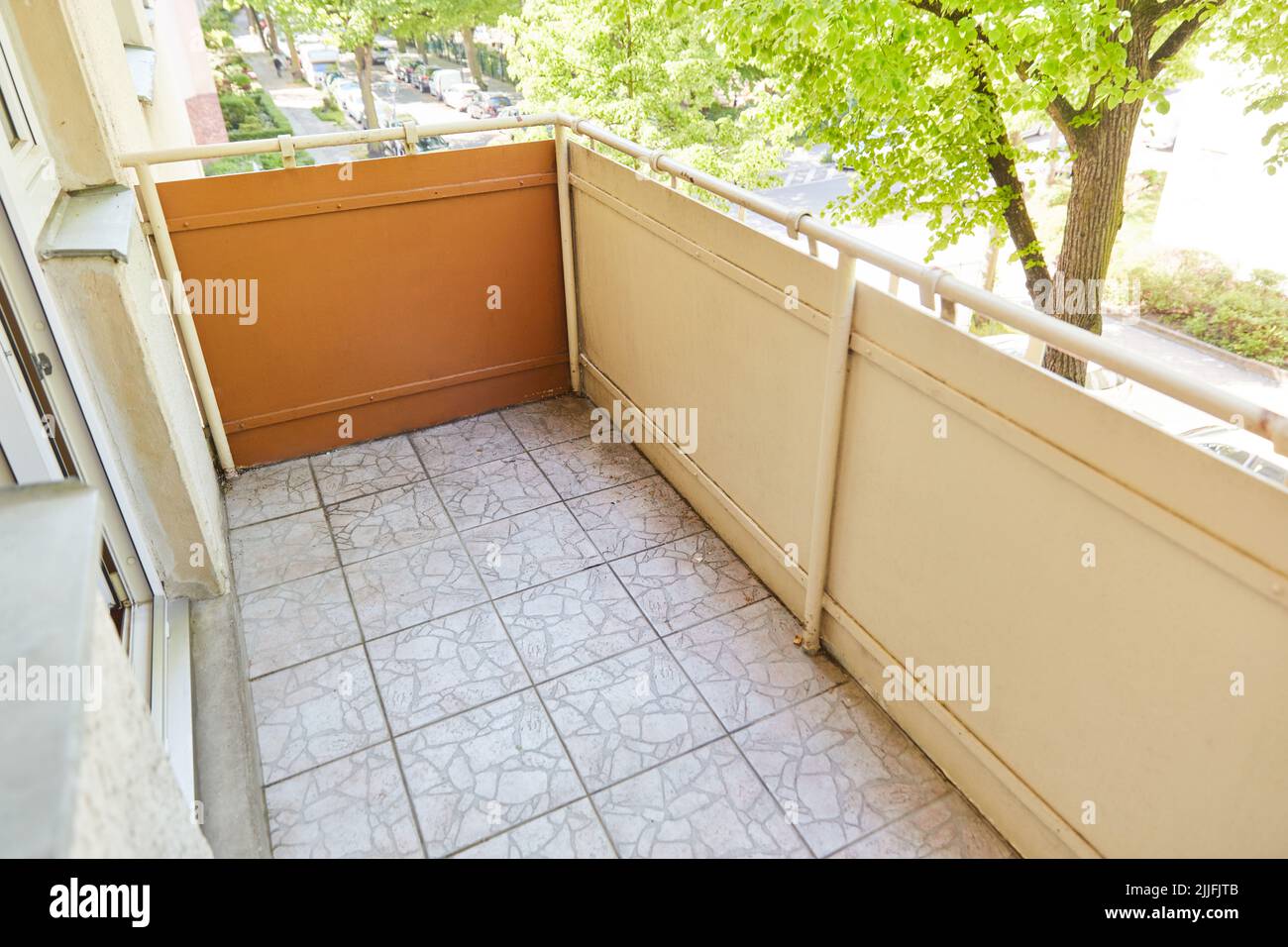 Empty balcony with tiles at a rented apartment in summer Stock Photo