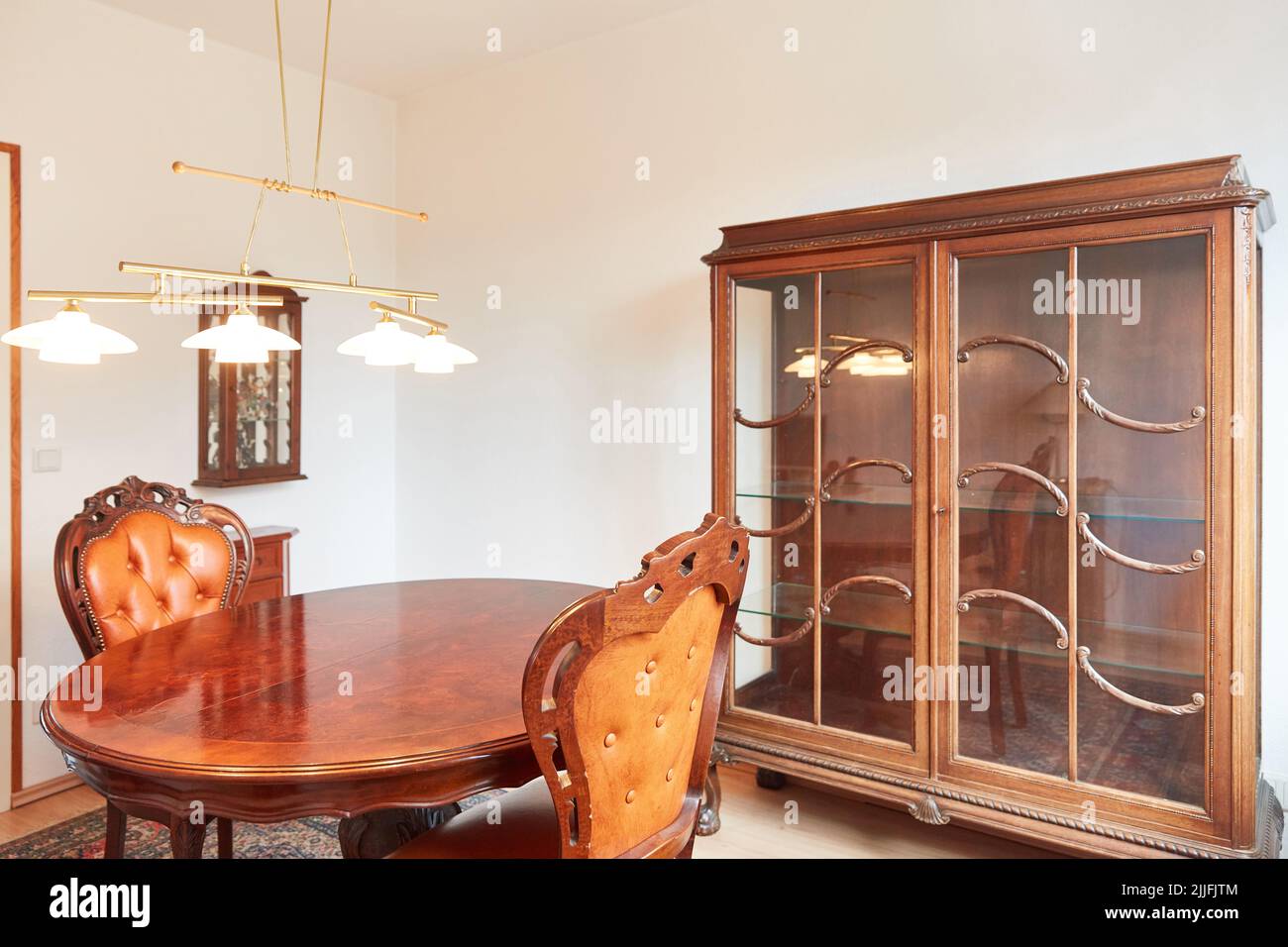 Antique dining table in dining room with retro look furniture Stock Photo