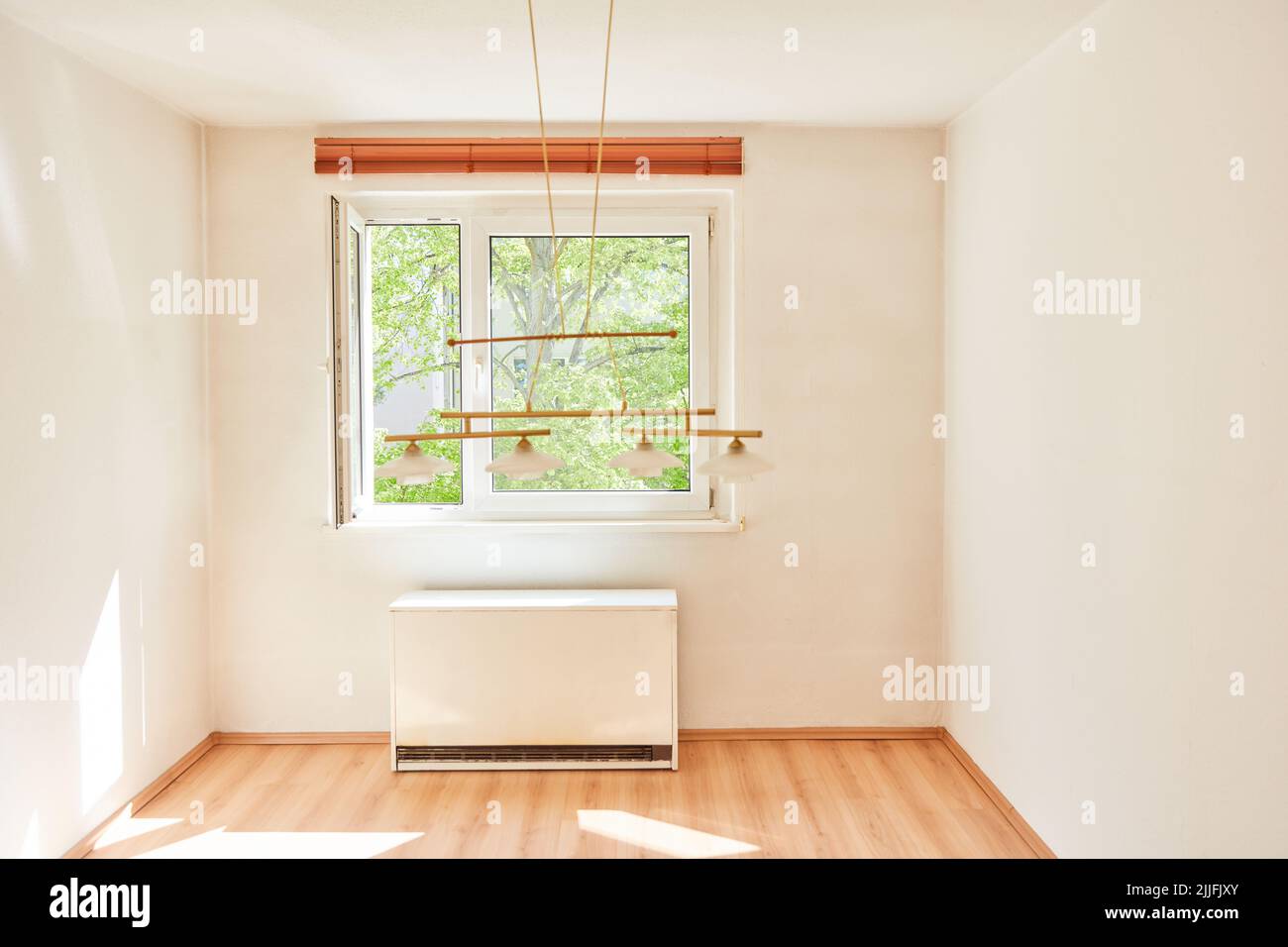 Small bright room with night storage heating in apartment Stock Photo