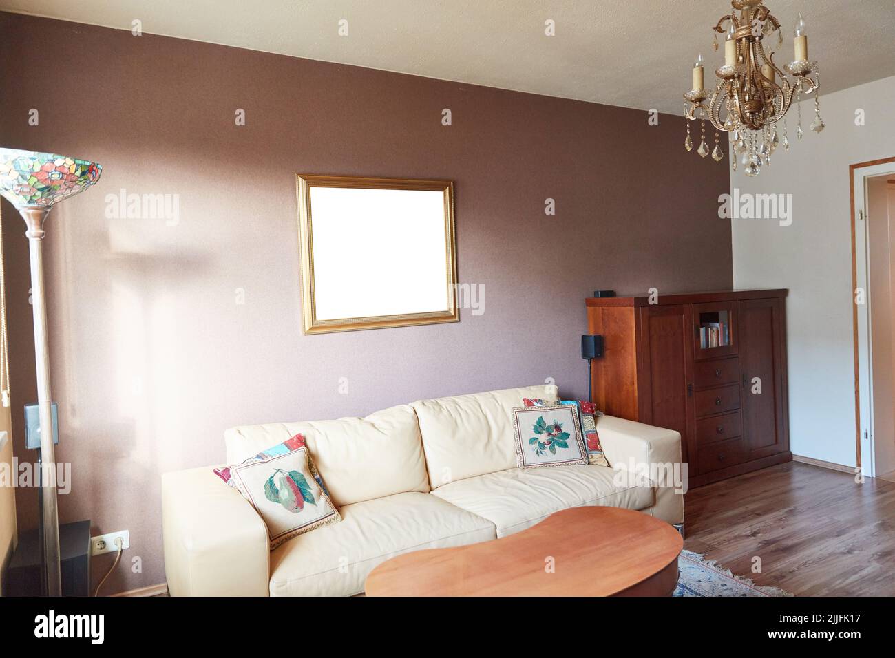 Old-fashioned living room with picture frame mock-up template on wall Stock Photo