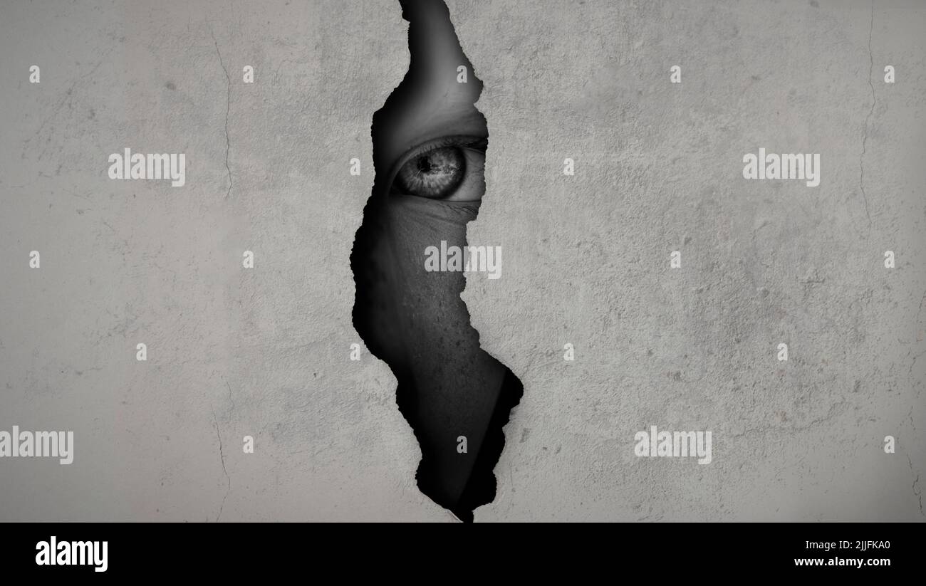 eye spying through crack Stock Photo
