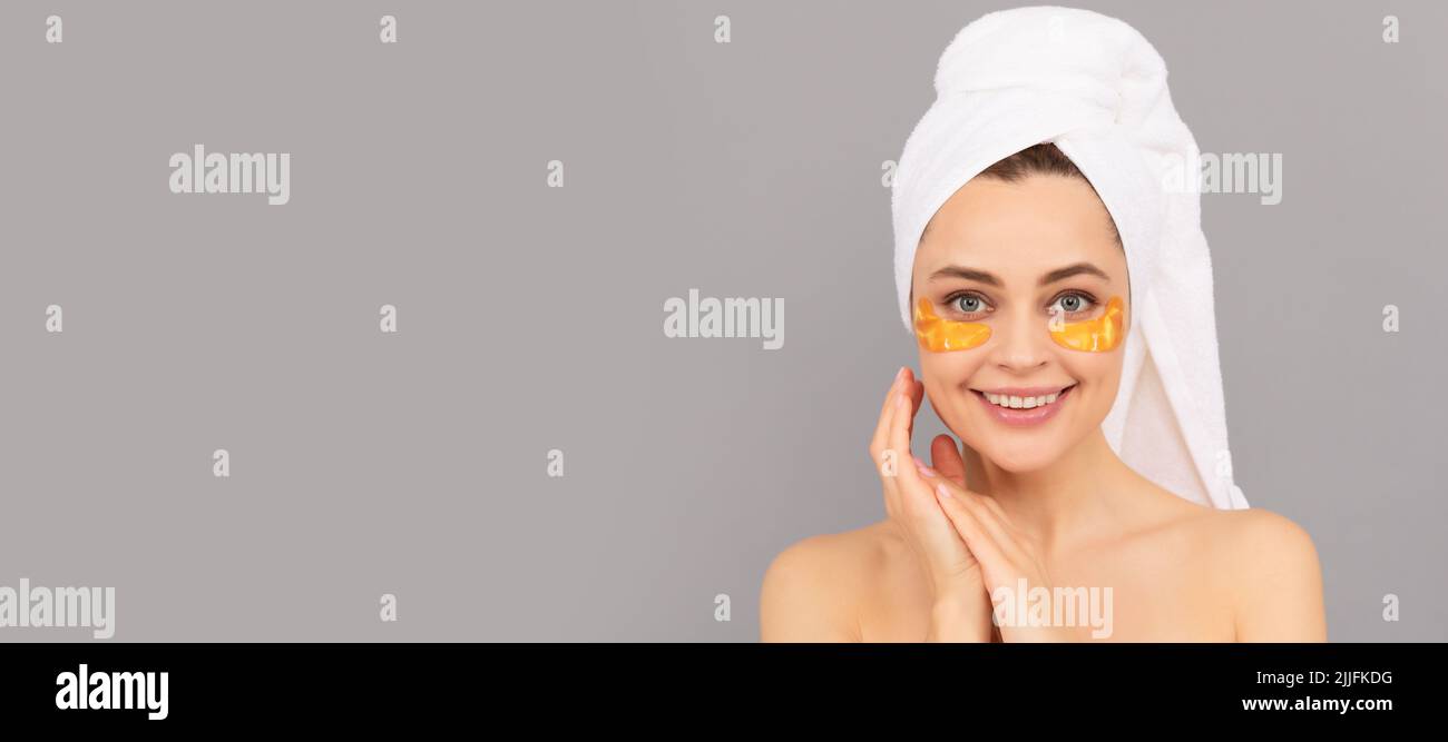 Eye patches, patch under eyes. happy woman with terry towel use facial golden eye patch for skin, skincare. Beautiful woman isolated face portrait Stock Photo