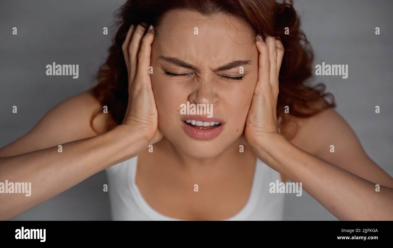 overhead view of woman with closed eyes suffering from headache Stock