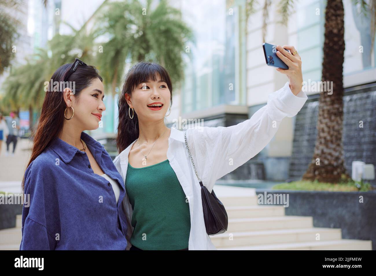 Happy two young women taking selfie on city street Stock Photo - Alamy