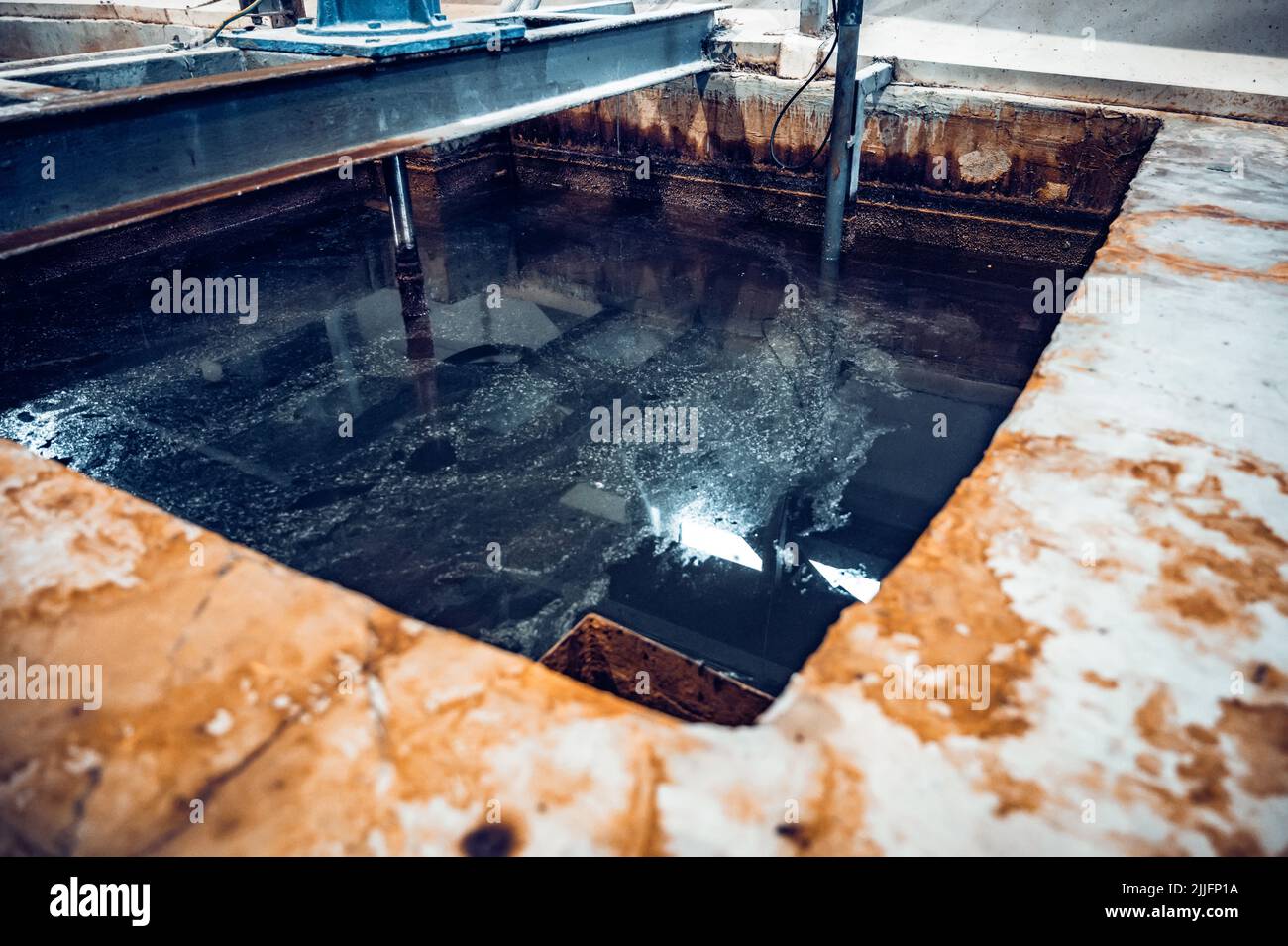 Liquid wastes. Polluted water after being used in steel factory. Pollution or contamination concept Stock Photo