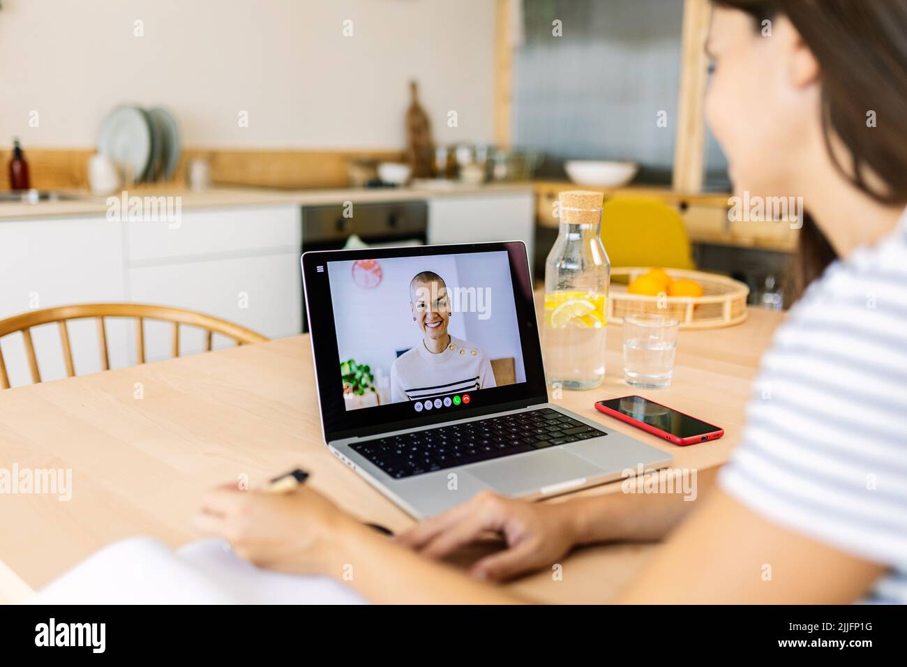Young business woman having a virtual video call with coworker from home Stock Photo