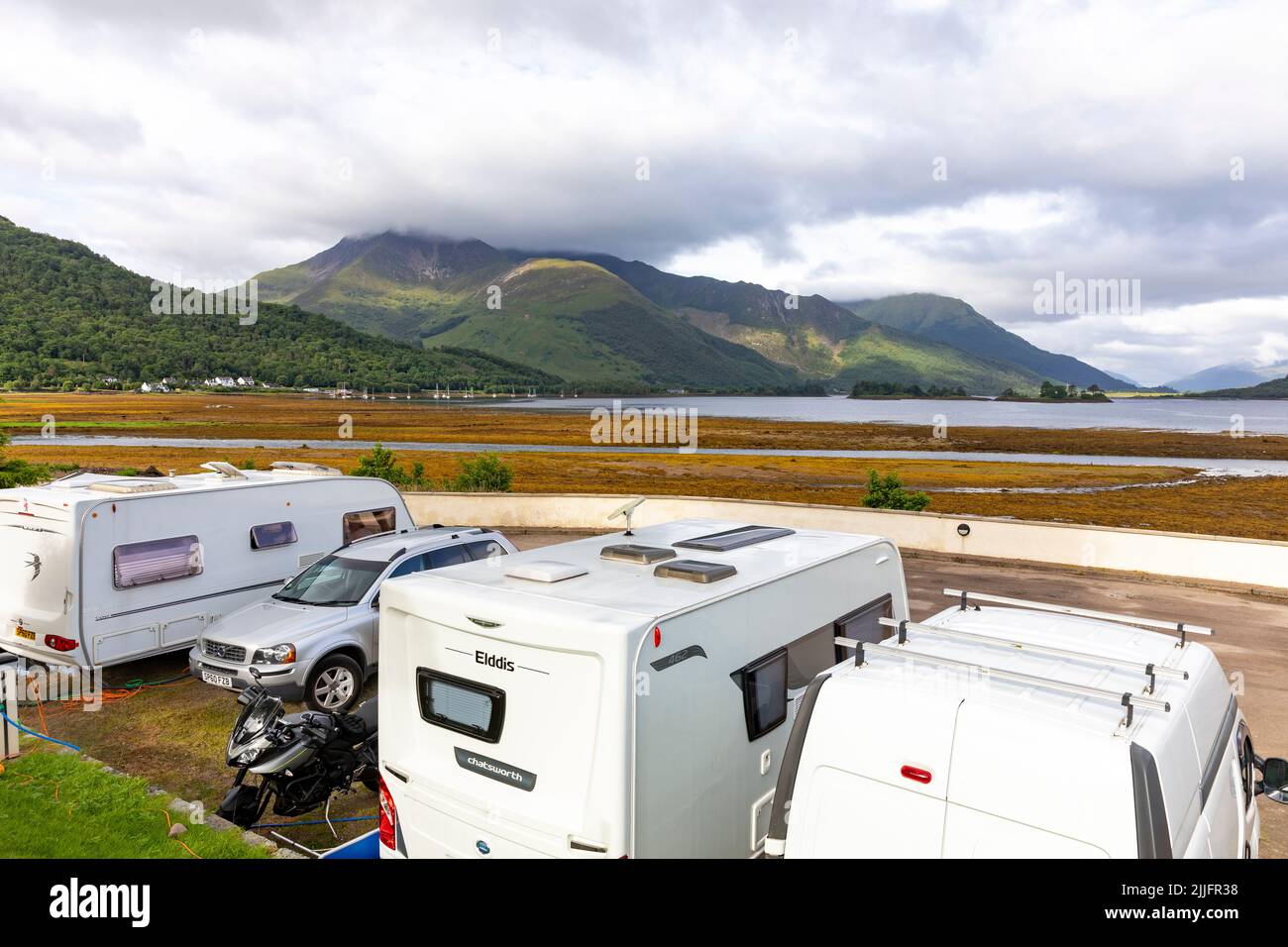 Glencoe in the Scottish highlands and Invercoe caravan and motorhomes park site with views over Loch Leven,Argyll,Scotland,UK,Europe Stock Photo