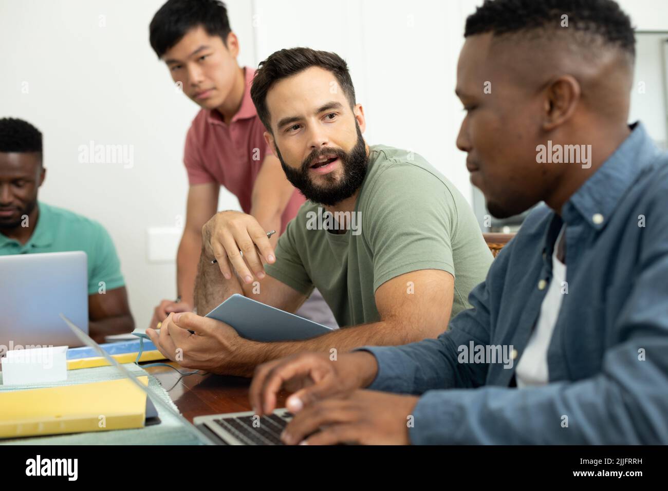 Multiracial male coworkers brainstorming ideas and strategies for achieving business goals Stock Photo