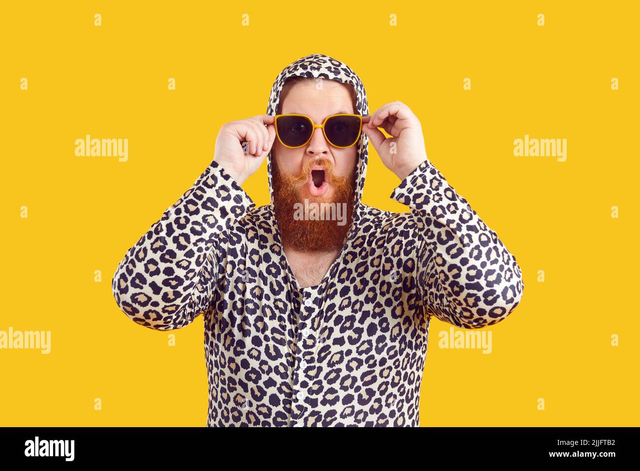 Eccentric bearded fat man with funny crazy shocked facial expression on