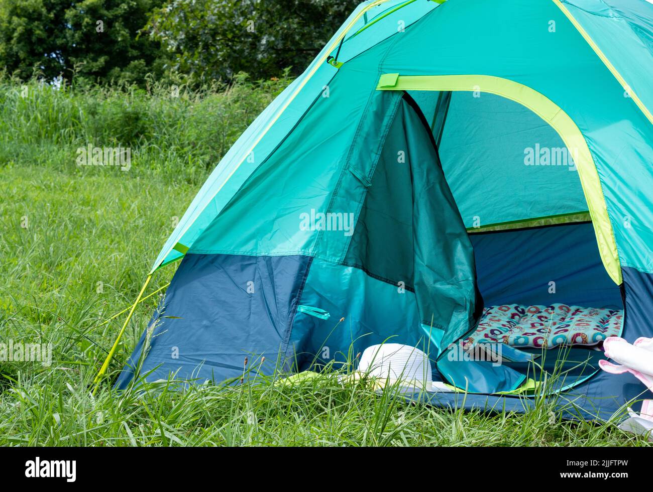 Camping tent in a lush, green meadow on a sunny day Stock Photo - Alamy