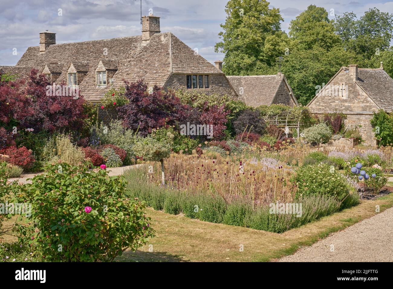 Traditional stone cottages and gardens in the Cotswolds, Gloucestershire Stock Photo