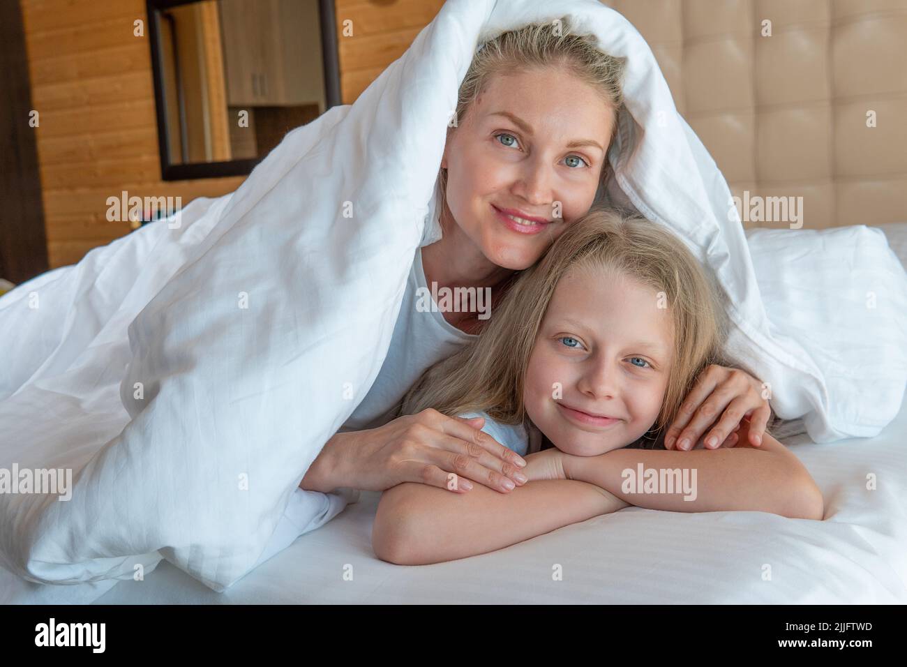Blanket over family woman glad daughter bed head girl beautiful, for view bedroom for caucasian from people calm, rest positive. Beauty relaxation Stock Photo