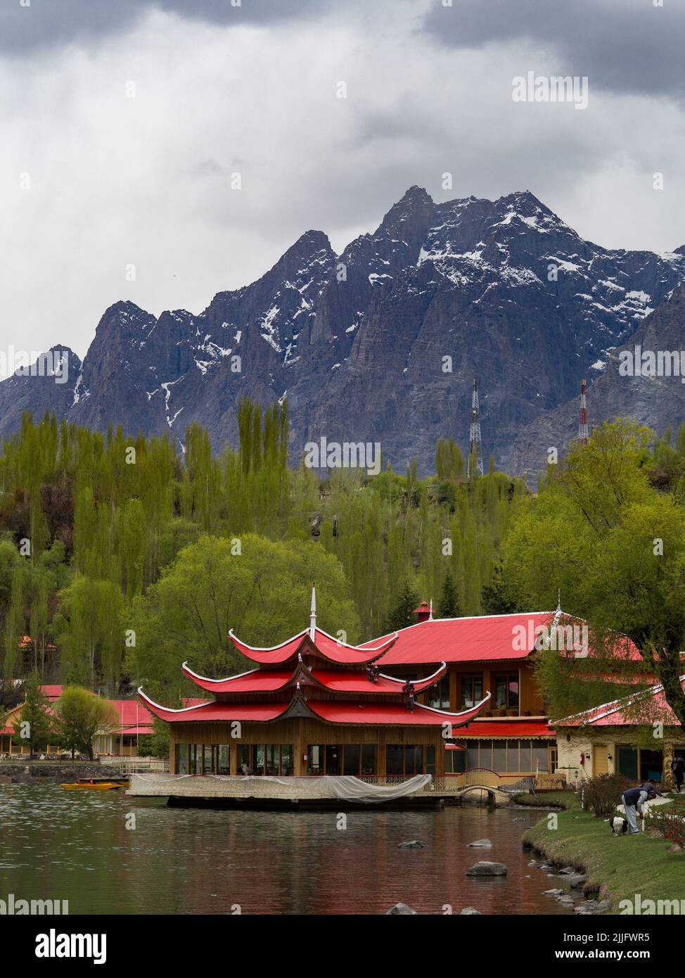 A vertical shot of Asian red-roof buildings on the shore of Upper Kachura Lake in Skardu, Pakistan Stock Photo