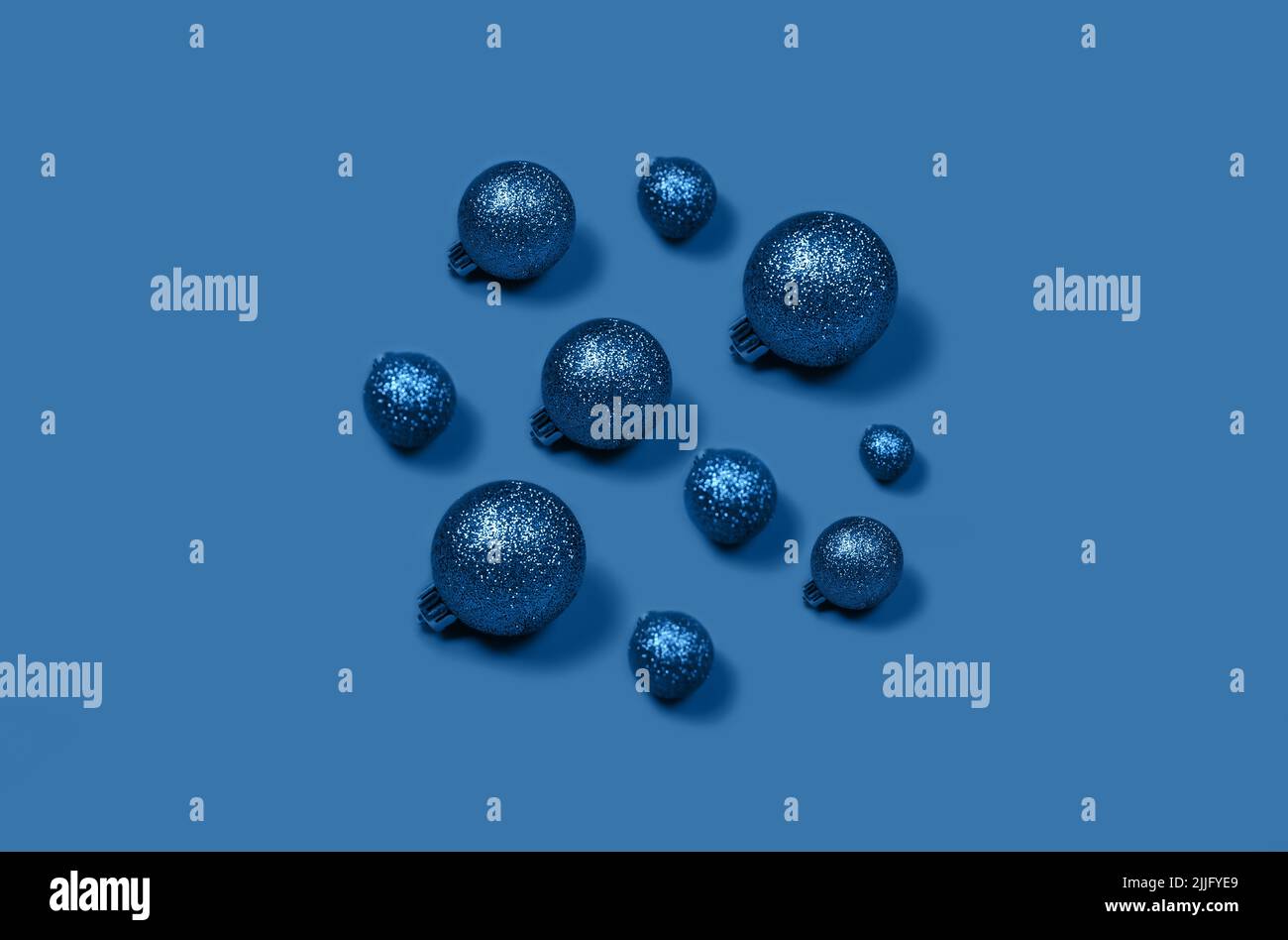 Volume Christmas composition of blue Christmas balls laid out in the form of circle on bright background. Stock Photo