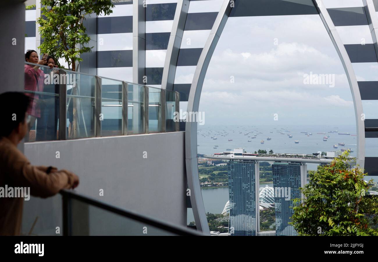 Visitors take in the view of the city skyline from a rooftop in the central business district in Singapore July 26, 2022. REUTERS/Edgar Su Stock Photo