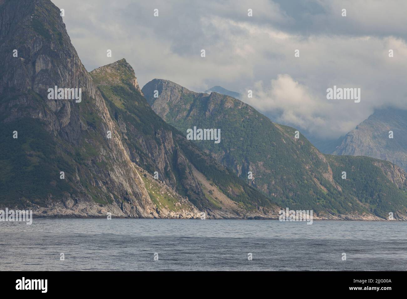 Closeup of a Norway rocky fjord with huge cliffs and a cloudy sky. Stock Photo