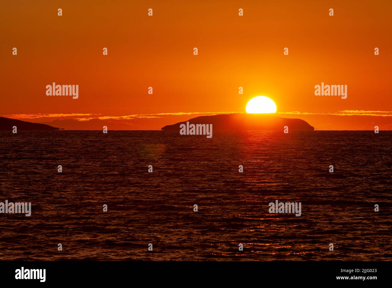 Midnight sun on the horizon above a Norway sea. Stock Photo