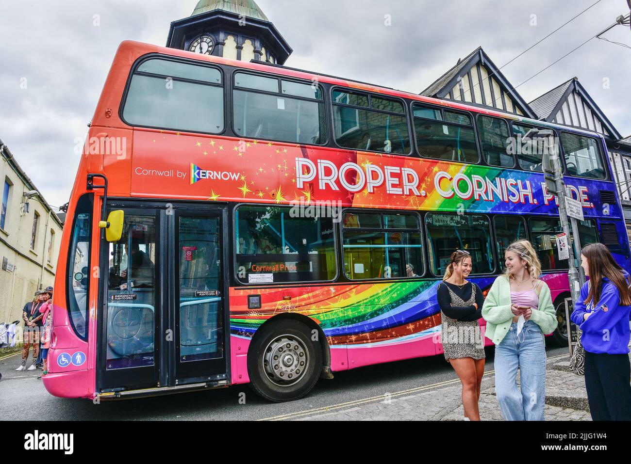 A double decker bus decorated and participating in the vibrant colourful Cornwall Prides Pride parade in Newquay Town centre in the UK. Stock Photo