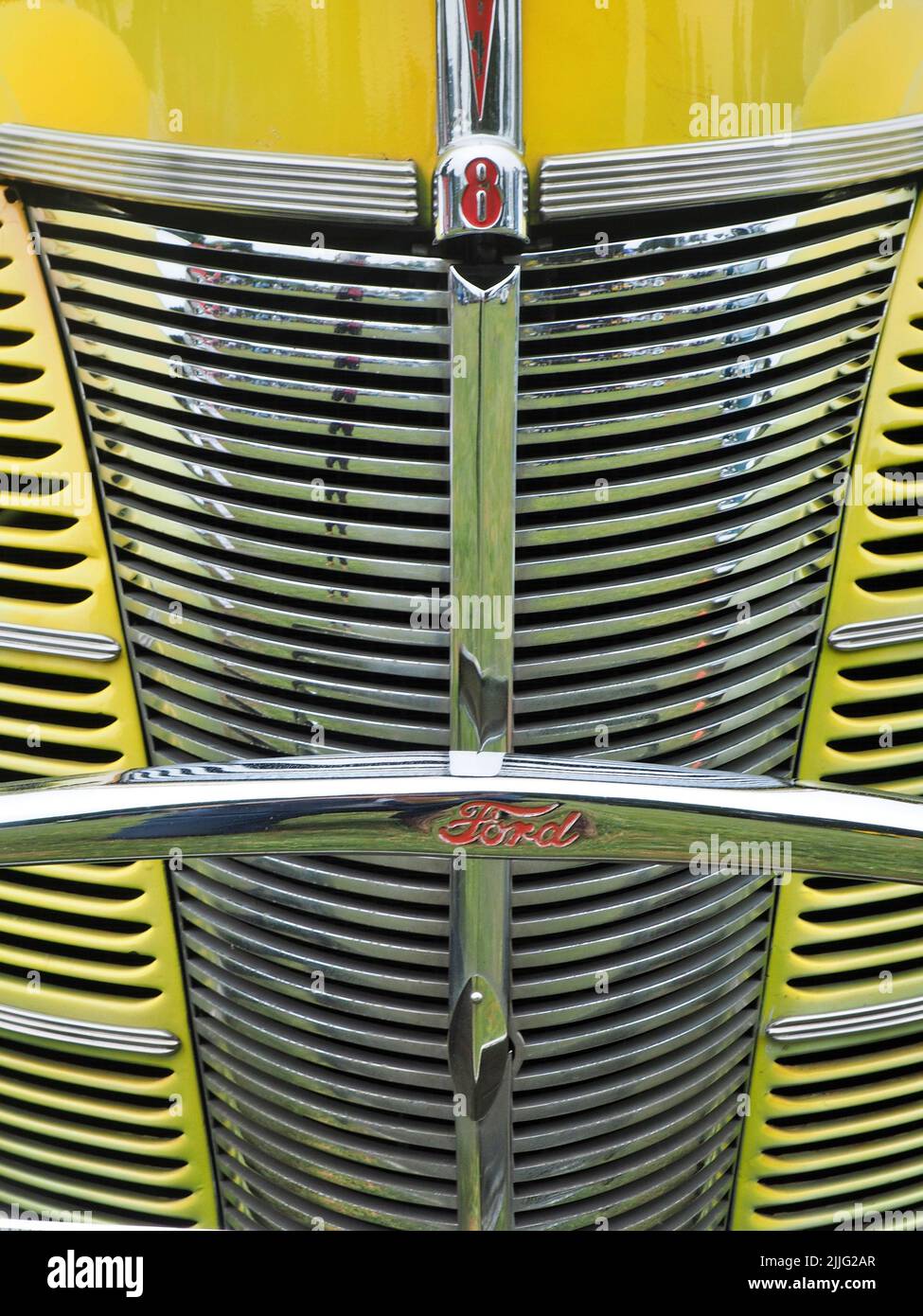 A yellow classic vintage Ford car hood detail at Hooligans