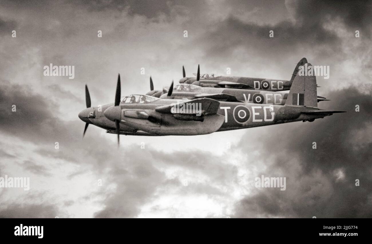 Three De Havilland Mosquito FB Mark VI Series 2s of No. 487 Squadron RNZAF based at Hunsdon, Hertfordshire, flying in tight starboard echelon formation, with 500-lb MC bombs on fitted on underwing carriers. The 'Wooden Wonder' or 'Mossie' was a British twin-engined, shoulder-winged, multirole combat aircraft, introduced during the Second World War. Unusual in that its frame was constructed mostly of wood. Stock Photo