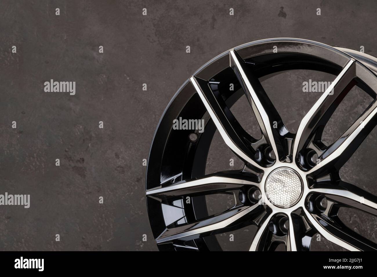 new alloy wheel, black with polishing on a close textured background  detail. a place for advertising and text of automotive products or a tire  store o Stock Photo - Alamy