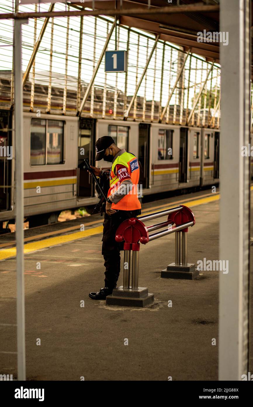 A vertical shot of a security guard on a Depok Railway Station, West Java Stock Photo