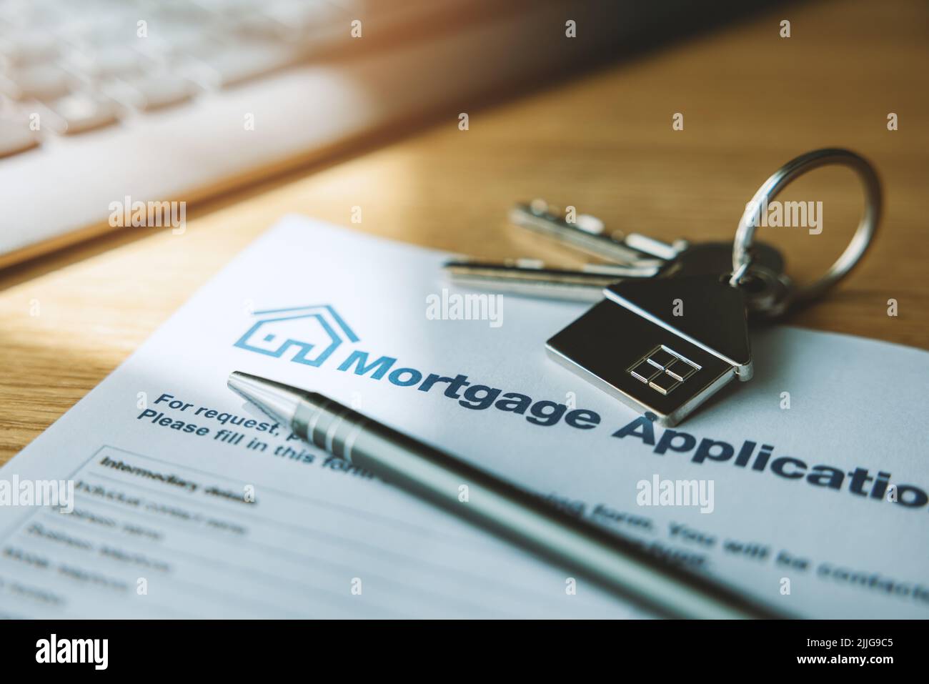 mortgage loan application document and new house keys on the bank office table Stock Photo