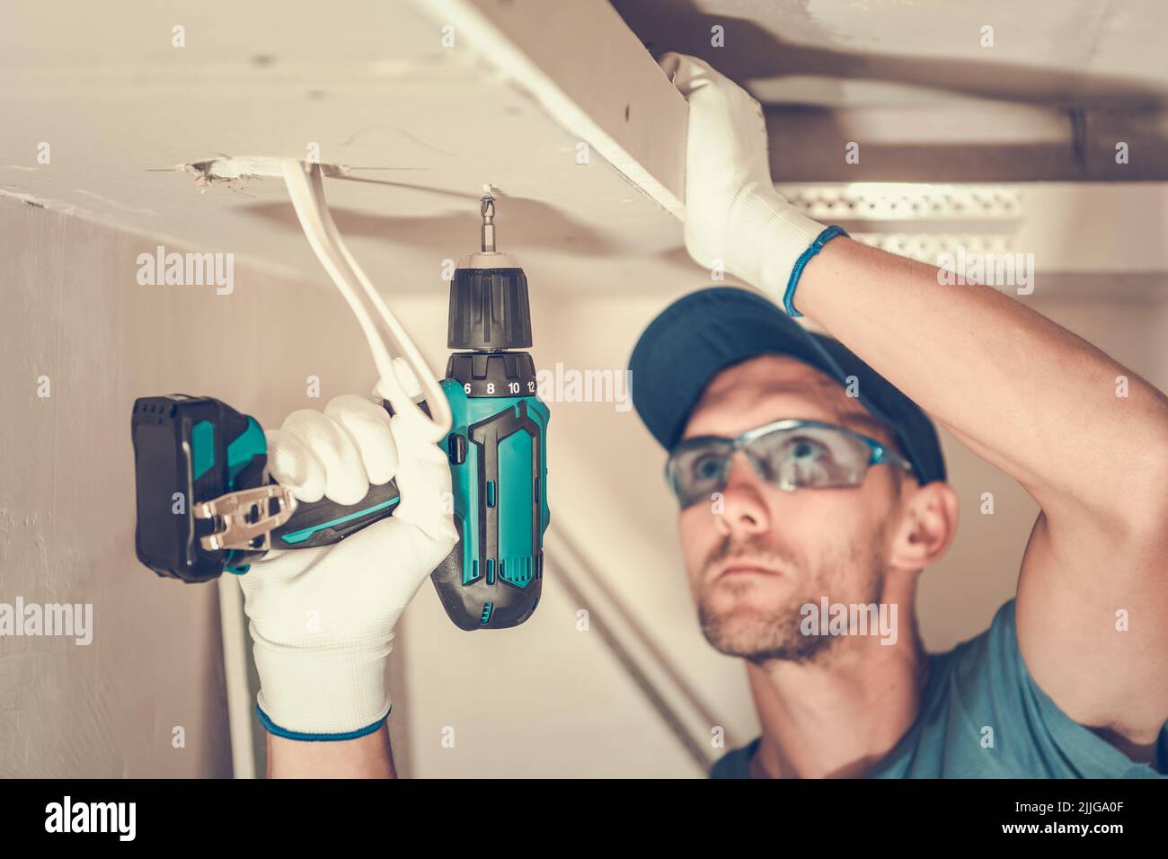 Closeup of Caucasian Contractor in His 40s Focused on Installation of