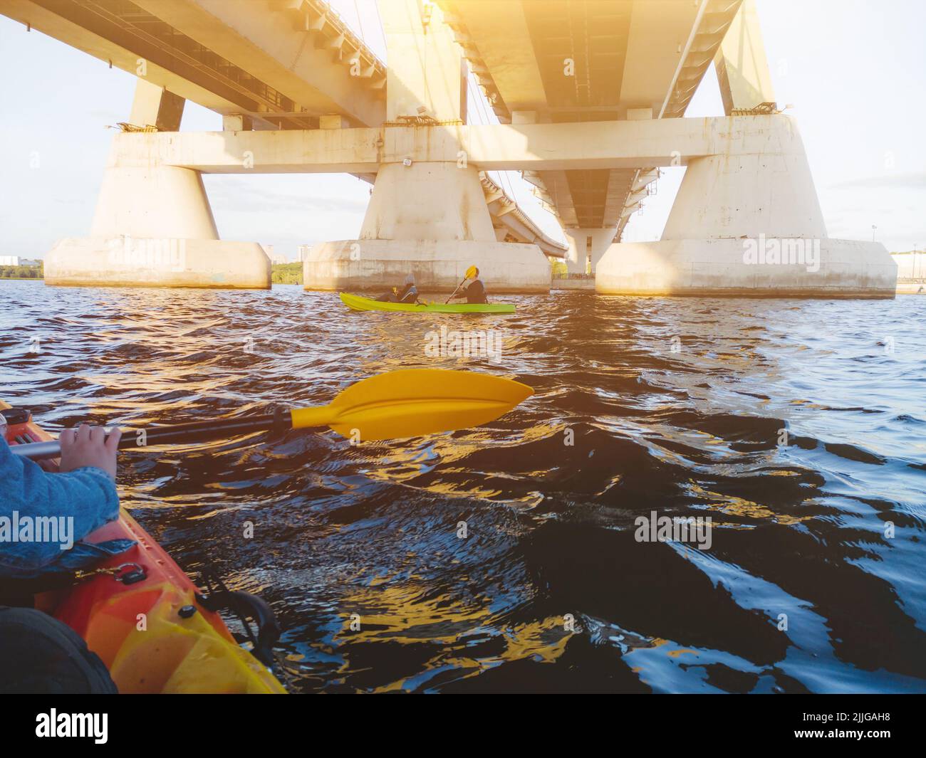 Kayaking at summer time. Kayak trip. Sunset view. Two paddles over the