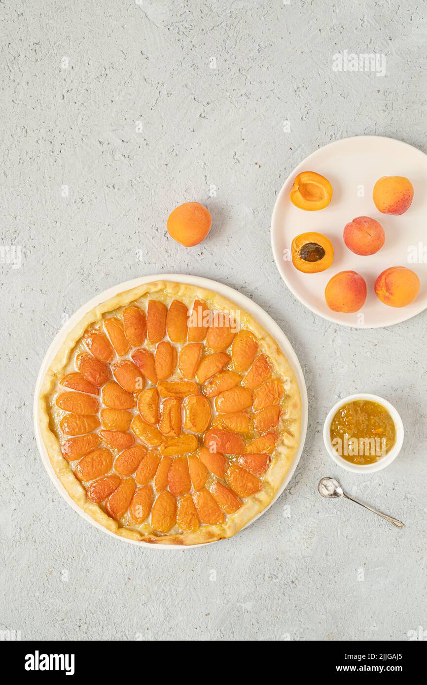 Peach-topped pizza and peaches on a gray background , homemade healthy food, top view with copy space Stock Photo