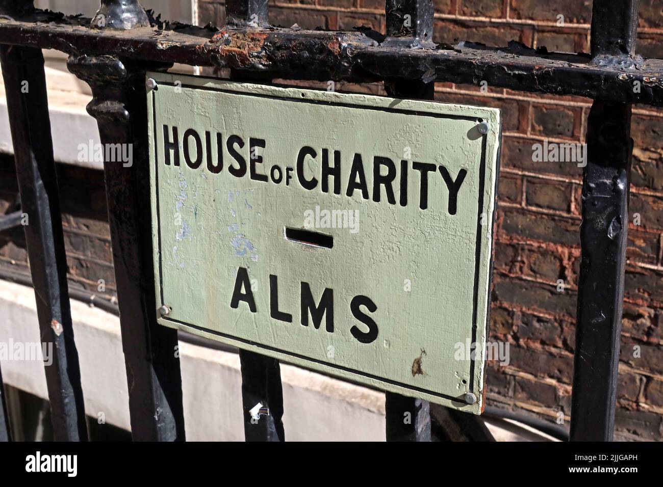 The penny chute, collection pipe, Alms for the House of Charity - The House of St Barnabas at 1, Greek Street, Soho, London, UK, W1D 4NQ Stock Photo