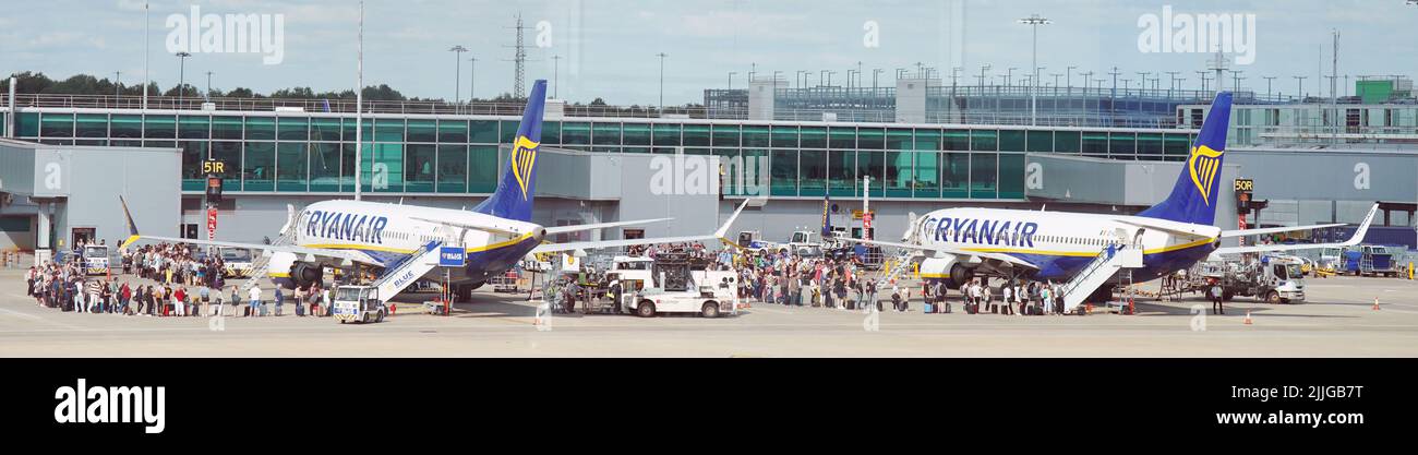 A stock picture of passengers queuing up to get on Ryanair planes at Stansted Airport. Picture date: Tuesday July 26, 2022. Stock Photo