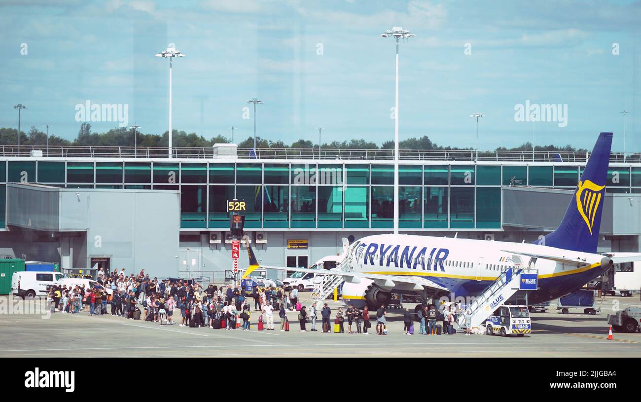 A stock picture of passengers queuing up to get on Ryanair planes at Stansted Airport. Picture date: Tuesday July 26, 2022. Stock Photo