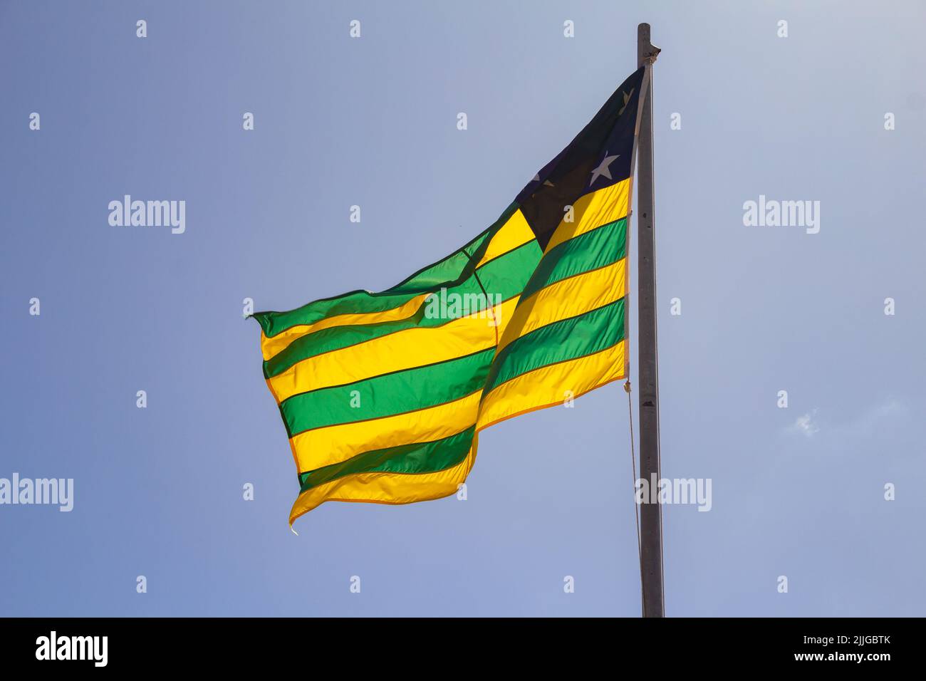 Brasília, Federal District, Brazil – July 23, 2022:  Goias state flag flying and fluttering in the wind with blue sky in the background. Stock Photo