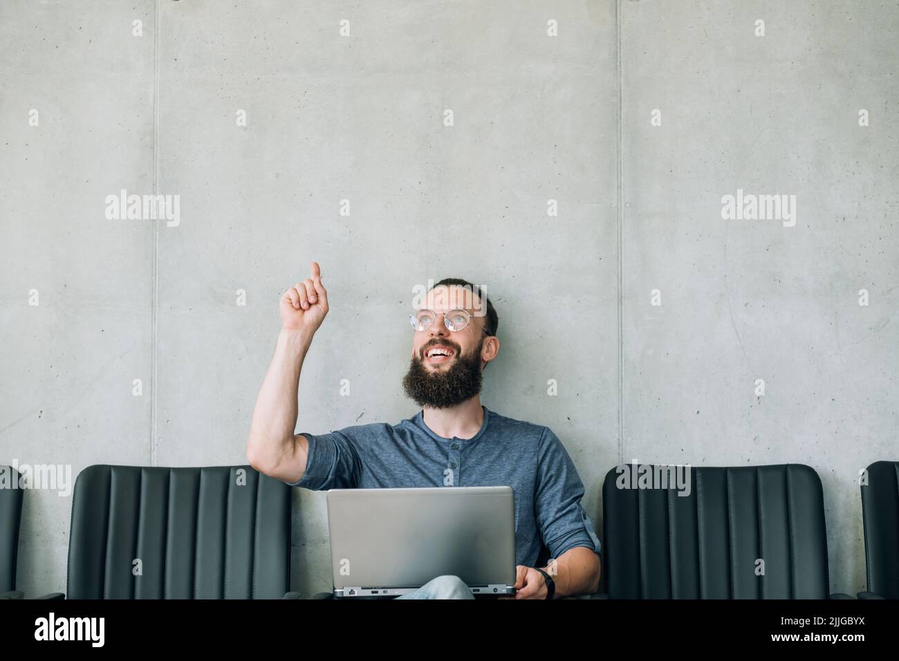 amazed smiling man point up office business employ Stock Photo