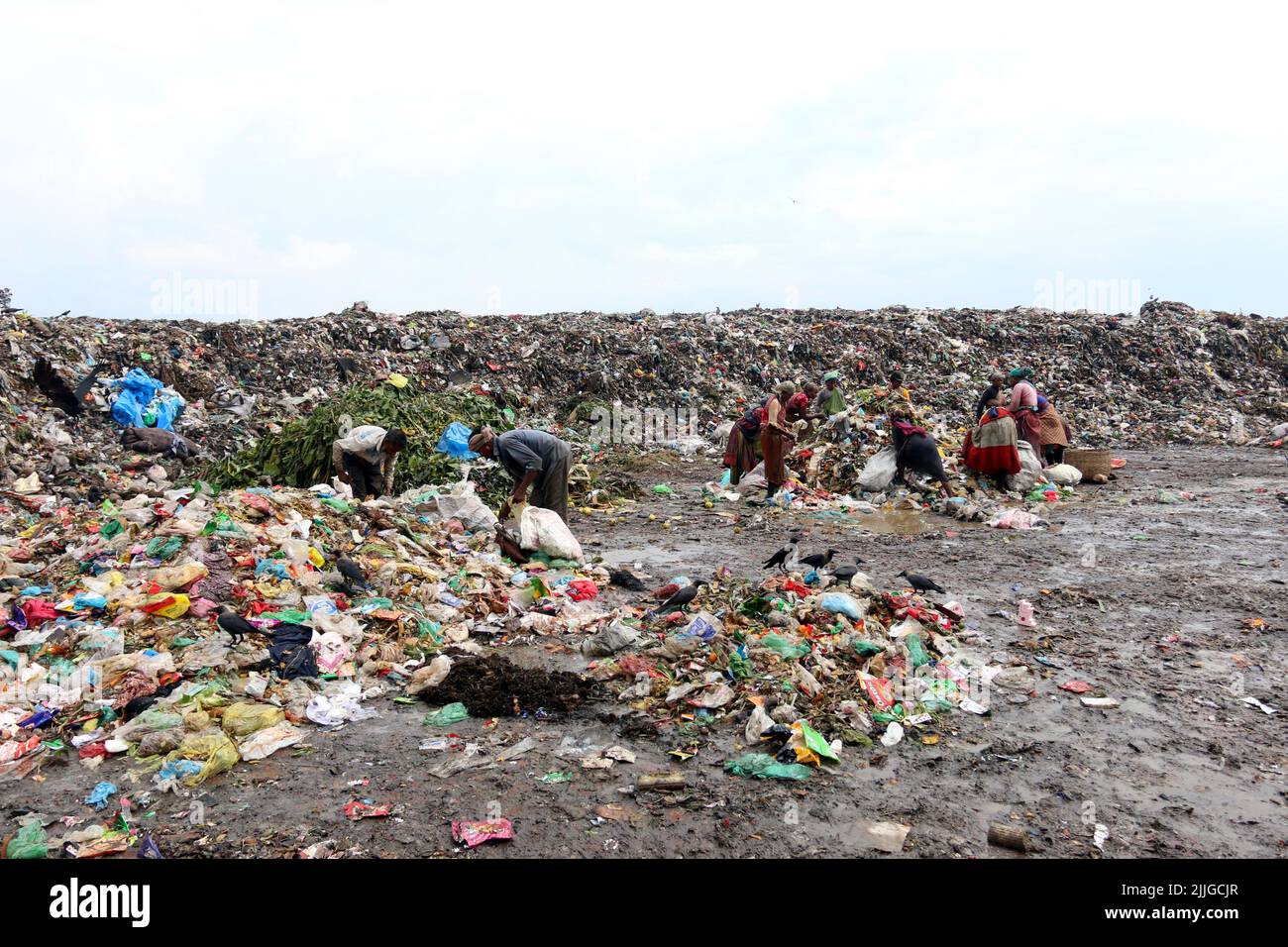 People recycle nonbiodegradable waste at a garbage dump in Dhaka to be