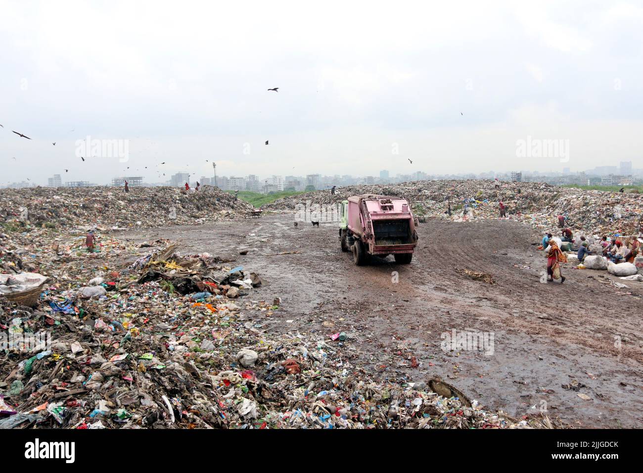 People recycle nonbiodegradable waste at a garbage dump in Dhaka to be