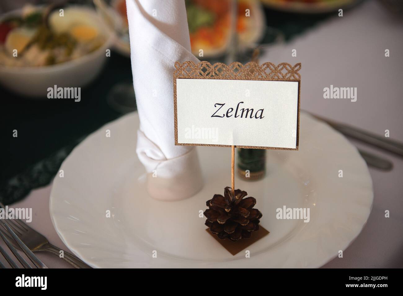 A closeup shot of a Zelma labelled pinecone at a wedding for a guest Stock Photo
