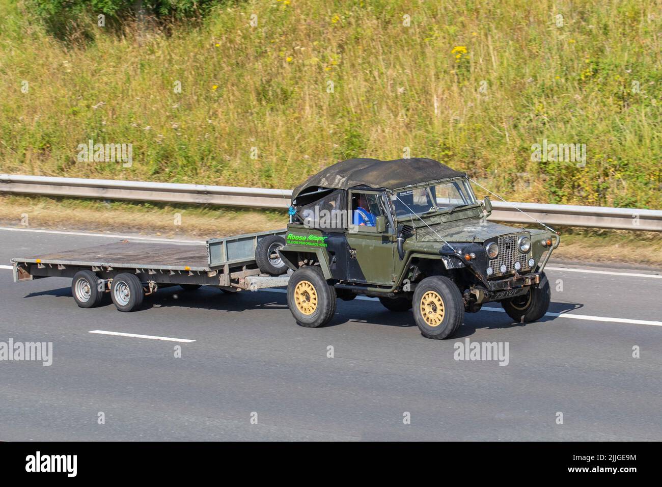 1958 50s fifties green British Land Rover 4x4 SWB Diesel 2495 cc towing empty 2axle road trailer on the M6 motorway UK Stock Photo