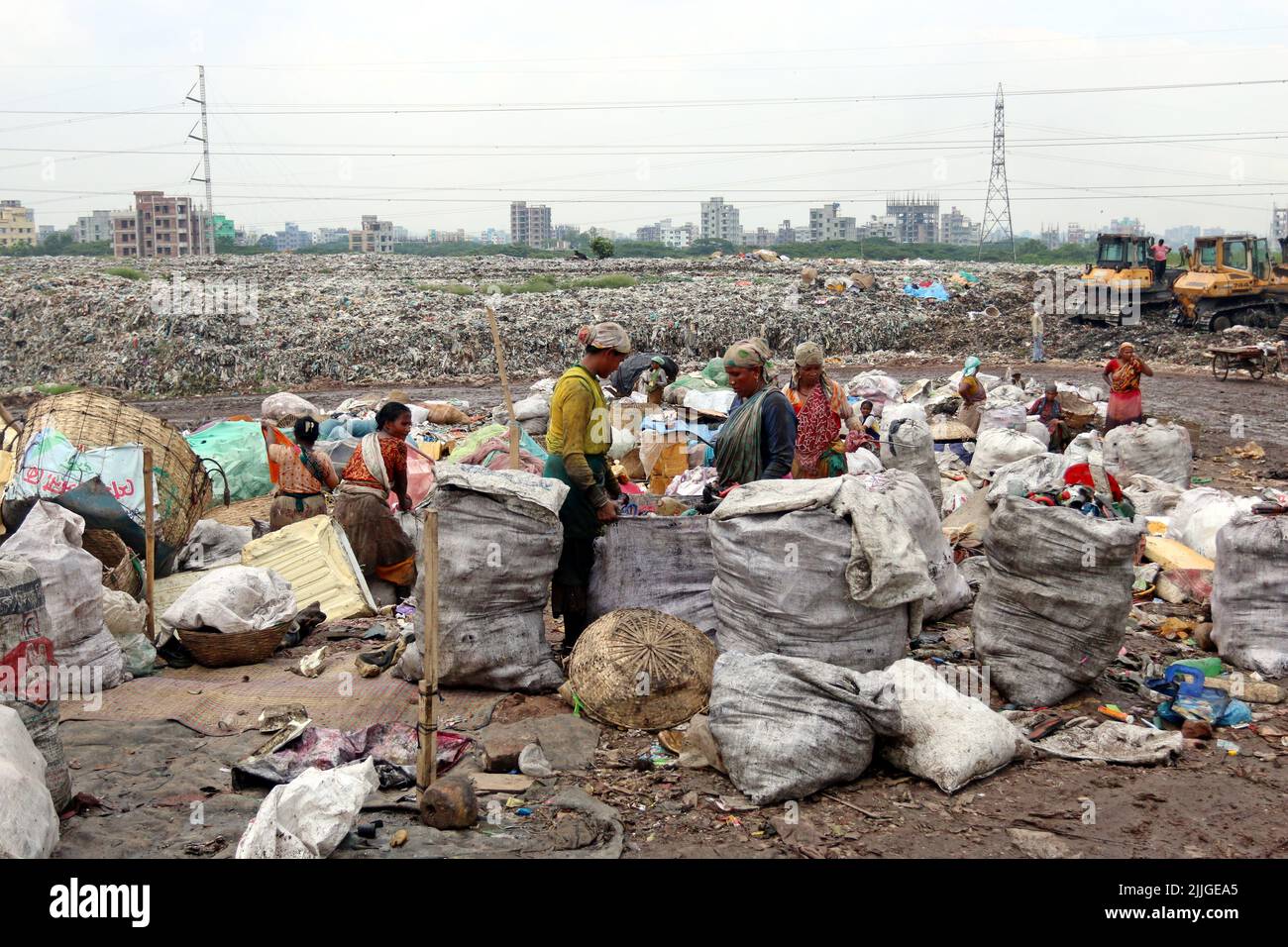 People recycle non-biodegradable waste at a garbage dump in Dhaka to be used in the recycling industry. In urban areas of Bangladesh around 25,000 ton Stock Photo