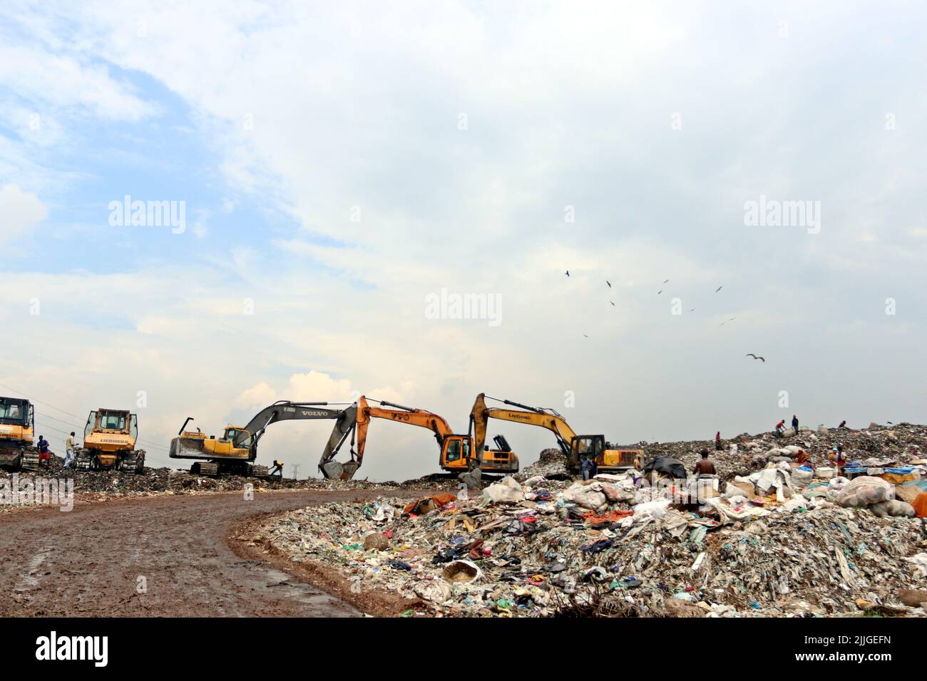 People recycle nonbiodegradable waste at a garbage dump in Dhaka to be