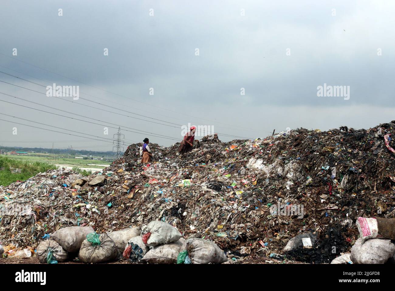 People recycle nonbiodegradable waste at a garbage dump in Dhaka to be