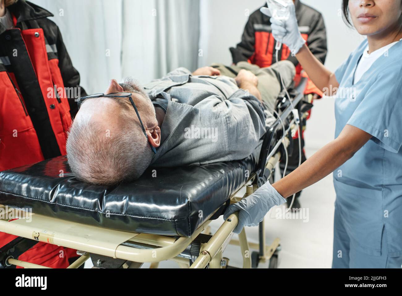 Horizontal shot of ambulance and emergency department workers bringing
