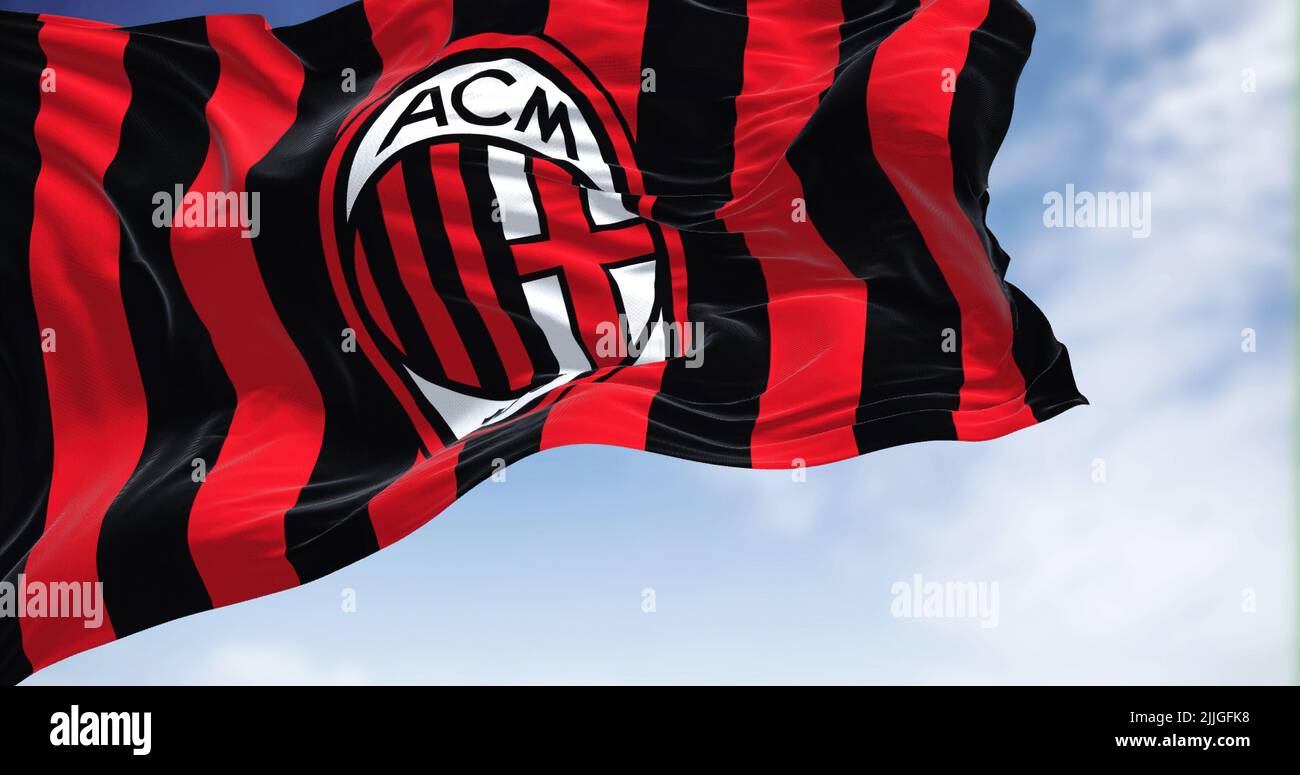 Milan, Italy, July 2022: The flag of A.C. Milan waving in the wind on a clear day. Milan is a professional football club based in Milan, Italy Stock Photo