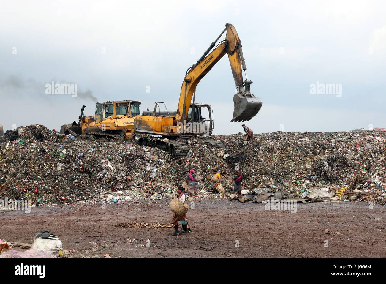People recycle nonbiodegradable waste at a garbage dump in Dhaka to be