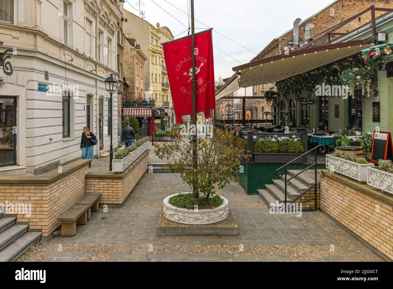 Belgrade, Serbia - March 15, 2022: Red Flag Pole Landmark at Vintage Street Bohemian Skadarlija in Old Town. Stock Photo