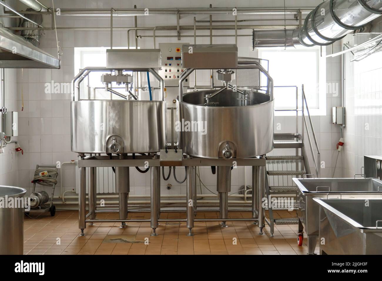 Dairy cheese factory interior with industrial appliances. Milk pasteurization, tank, bath and pipes. No people Stock Photo