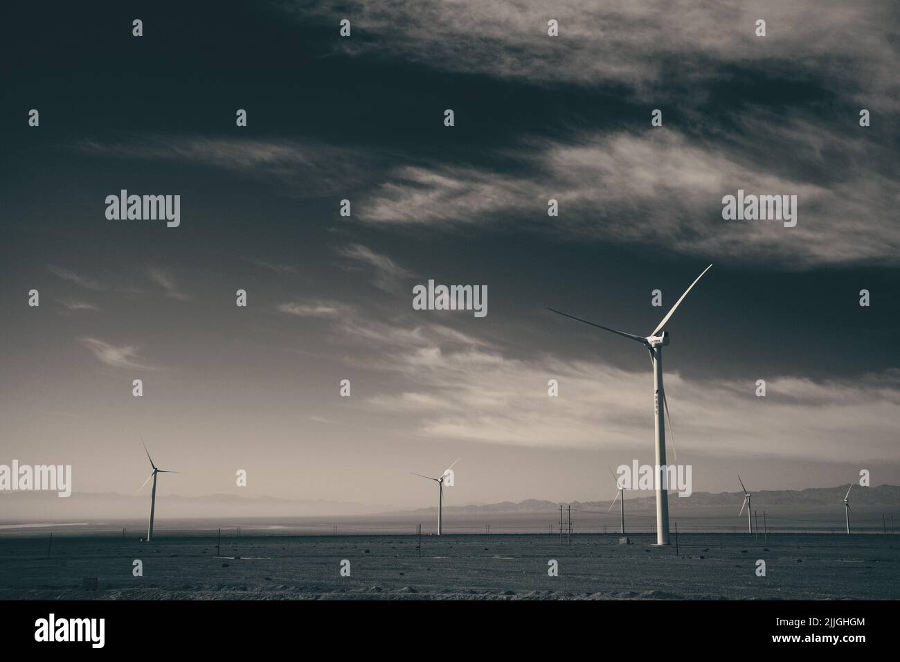 A wind turbines under a cloudy dark sky Stock Photo - Alamy