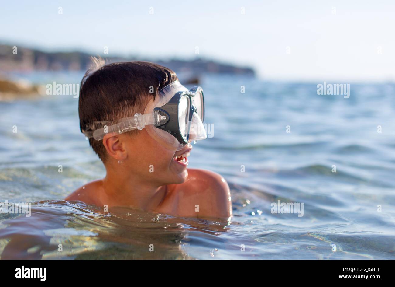 Young boy in sea with goggles Stock Photo