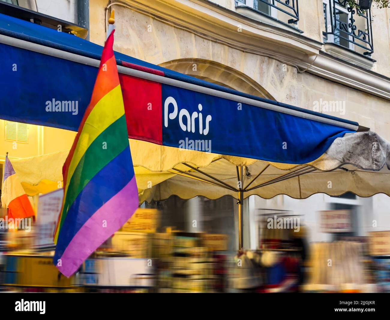 Storefront of bookstore or souvenir shop in Paris, France with LGBT flag in front of it Stock Photo